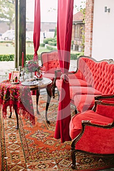 Festive table setting in national Russian style. Red color in decor and decoration of event.