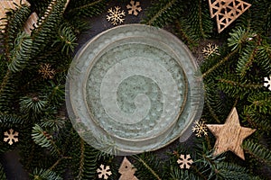 Festive table setting near fir tree branches and Rustic Christmas decorations on dark table top view