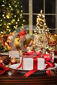 Festive table setting with red ribbon gift