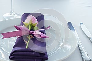 Festive table setting in the restaurant with flowers.