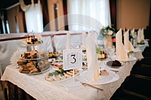 Festive table setting in restaurant, food on the tables for a wedding dinner in a restaurant