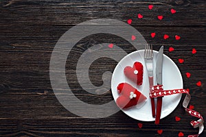 Festive table setting for Valentine`s Day with fork, knife and h