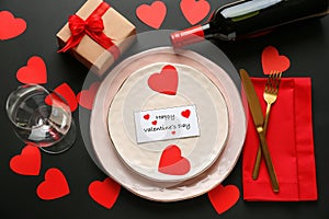 Festive table setting for Valentines Day celebration on dark table