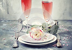 Festive table setting for valentines day, plates and glasses wit