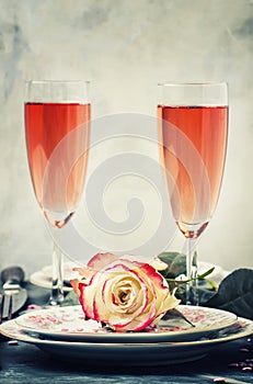 Festive table setting for valentines day, plates and glasses wit