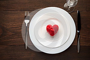 Festive table setting for Valentines day on rustic wooden table.