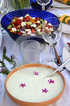 Festive table with tzatziki and colorful salad