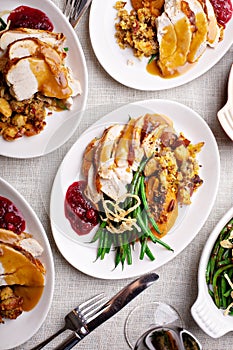 Festive Thankgiving dinner table with plates of food