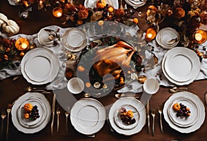 Festive Thanksgiving dinner table with a white tablecloth decorated with dishes