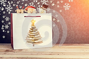 Festive white paper-bag with christmas tree, snowflakes and christmas cartoon papercut style with free copy space for your text