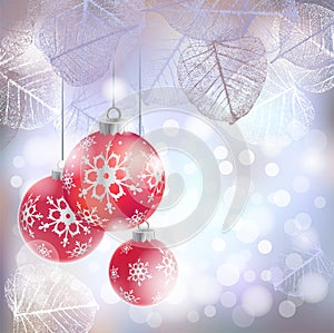 Festive winter background with red holiday balls against bokeh lights and frame of hoarfrost leaves