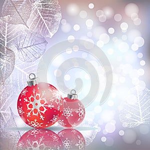 Festive winter background with red holiday balls against bokeh lights and frame of hoarfrost leaves