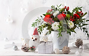 Festive winter flower arrangement in vase .