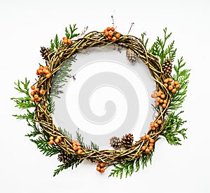 Festive wreath of vines with thuja branches, rowanberries and cones. Flat lay, top view