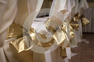 Festively decorated chairs with a yellow bow. festive event