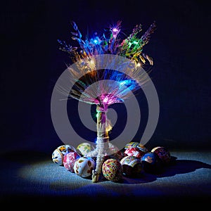 Festively decorated Christmas straw tree with colored eggs and illumination