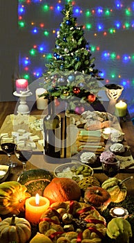 Festively decorated Christmas tree on table with candles and illumination