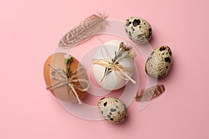 Festively decorated eggs on pink background, flat lay. Happy Easter