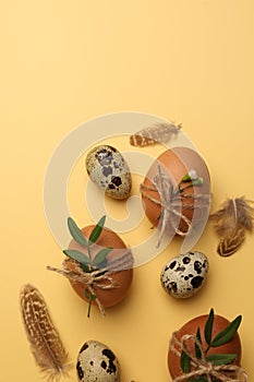 Festively decorated eggs on yellow background, flat lay. Happy Easter