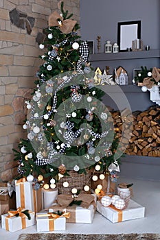 Festively decorated living room with Christmas tree and garland. Christmas room interior in scandinavian style. Christmas tree wit