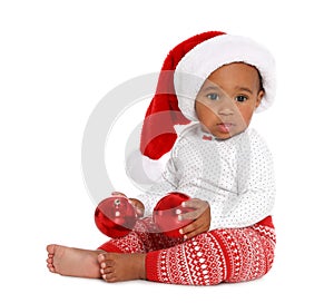 Festively dressed African-American baby with Christmas decorations on white