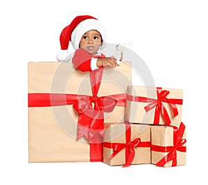 Festively dressed African-American baby with Christmas gifts and toy