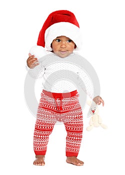 Festively dressed African-American baby with toy on white. First Christmas