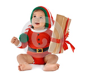 Festively dressed baby with gift box on background. Christmas celebration