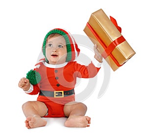 Festively dressed baby with gift box on white. Christmas celebration