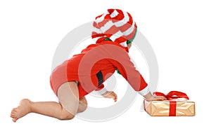 Festively dressed baby with gift box on white. Christmas celebration