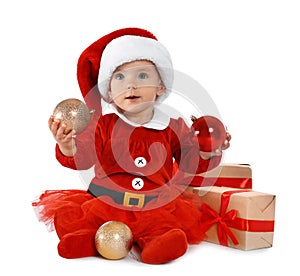 Festively dressed baby with gift boxes on white. Christmas celebration