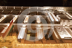 Festively Illuminated Building and Hungarian Flag