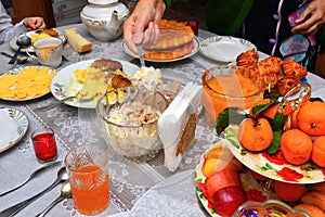 Festively laid table. Beautifully decorated dishes. Hand puts a spoon salad.