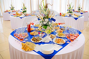 Festively laid tables at the Banquet. Various delicacies, snacks and drinks. Catering