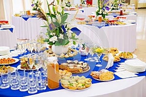 Festively laid tables at the Banquet. Various delicacies, snacks and drinks. Catering