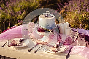 Festively served table with lavender bouquets and cake