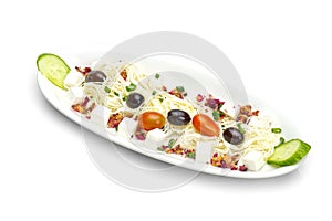Feta cheese cut in cubes, vegetables, herbs and olives