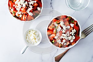 Feta cheese tomato salad in a white bowl