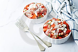 Feta cheese tomato salad in a white bowl