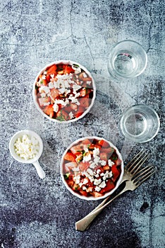 Feta cheese tomato salad in a white bowl