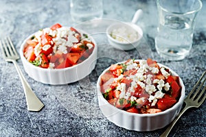 Feta cheese tomato salad in a white bowl