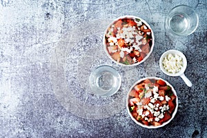 Feta cheese tomato salad in a white bowl