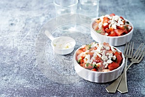 Feta cheese tomato salad in a white bowl