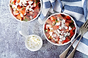 Feta cheese tomato salad in a white bowl