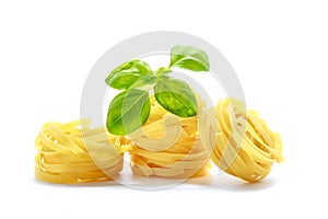 Fettuccine italian pasta with basil isolated on white background.