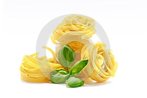 Fettuccine italian pasta with basil isolated on white background