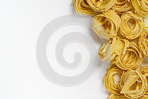 Fettuccine italian pasta isolated on white background. Raw tagliatelle nests isolated on white background. Traditional