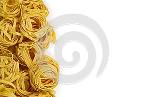 Fettuccine italian pasta isolated on white background. Raw tagliatelle nests isolated on white background. Traditional