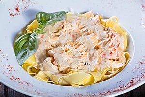 Fettuccine pasta with seafood, squid rings, shrimp, mussels, oysters, tomato, parmesan cheese