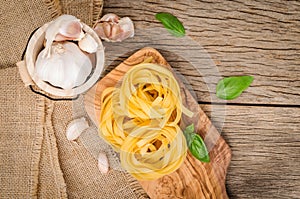 Fettuccine pasta set up on cutting wood. Fettuccine pasta ingredients for Italian food